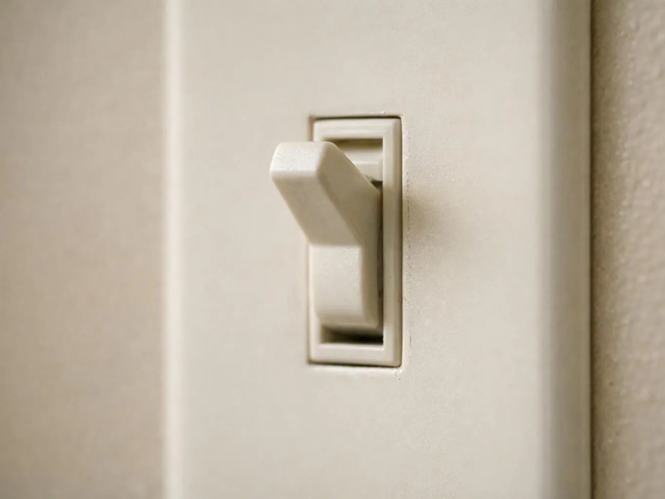 Electrician testing a breaker panel inside a Kenwood home